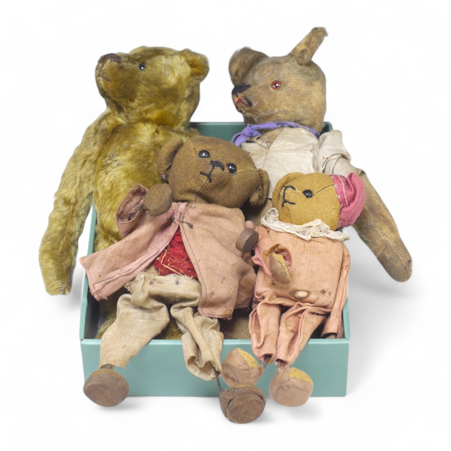 An early 20th century German hump backed plush teddy bear and three others, German teddy 30cm high. Condition - the German teddy has a short split on the back seam and glue on the front leg that needs removing and plush